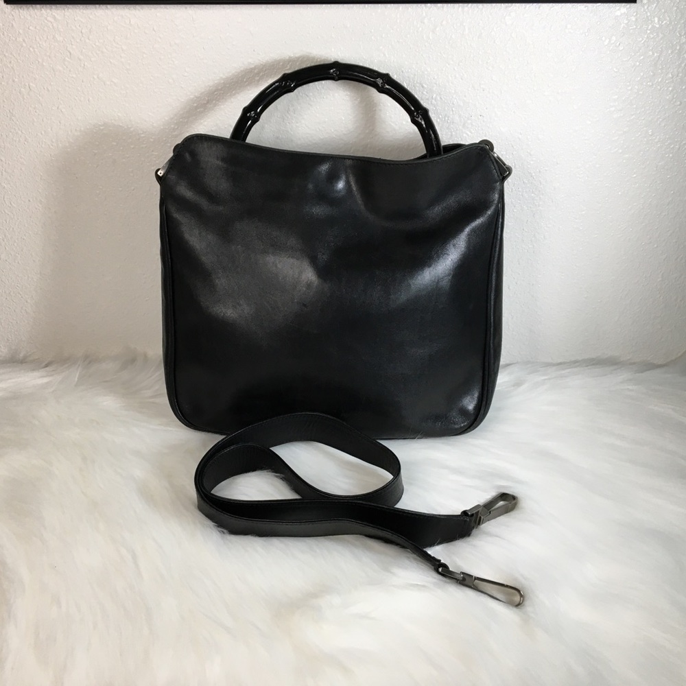 Gucci Black leather handbag with bamboo handle. Comes with Strap